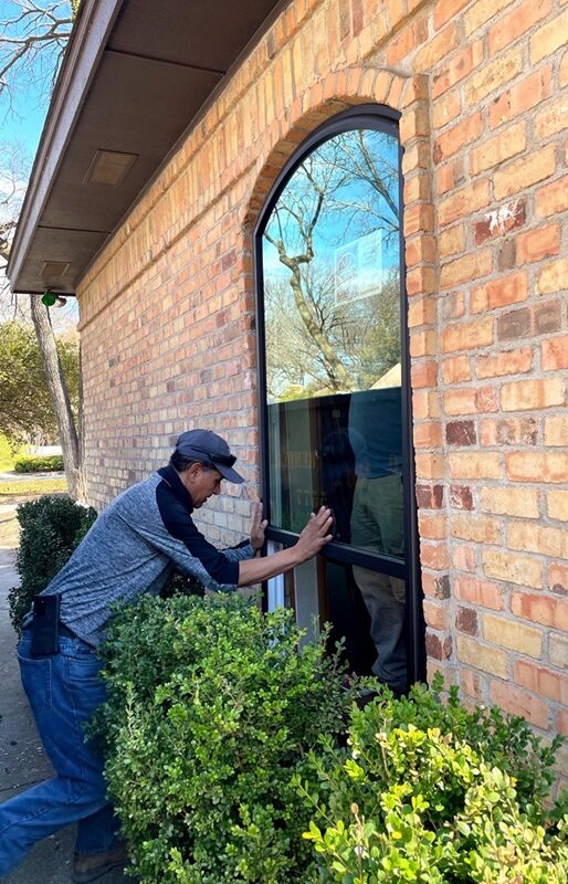 A-man-installing-energy-efficient-picture-replacement-windows-in-deer-park-ny